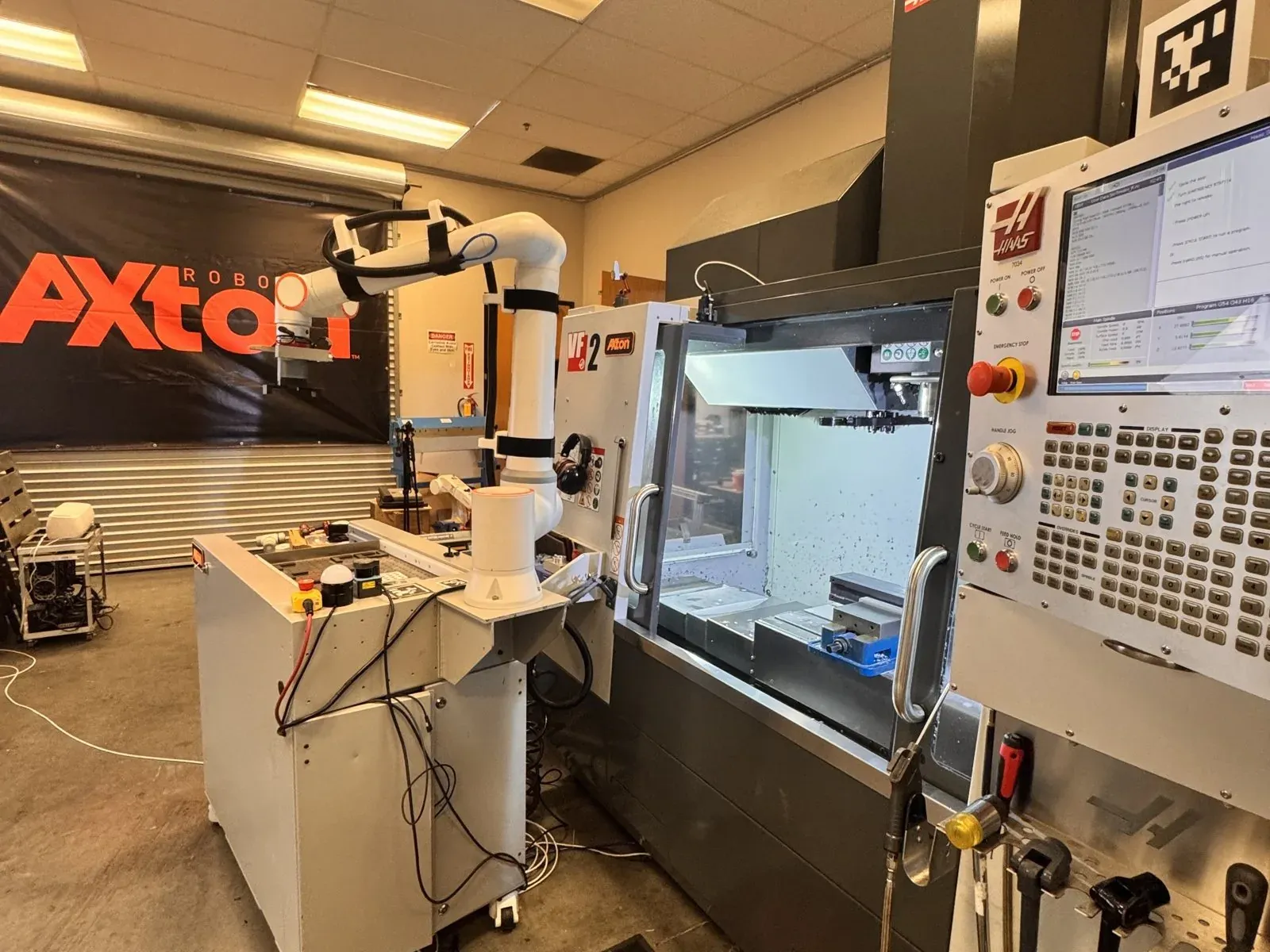 Axton robotic cell tending a Haas VF-2 CNC mill in the Axton shop in San Diego